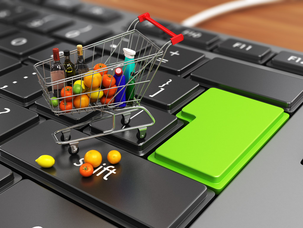 food basket on keyboard concept of electronic purchases