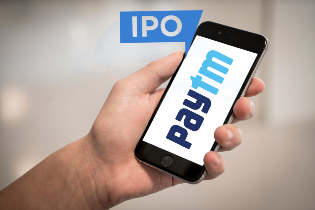 Person Holding Iphone Displaying Paytm Logo