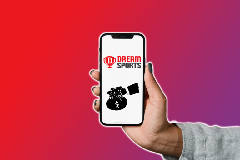 A woman holding smartphone in her hand with Dream Sports logo on it