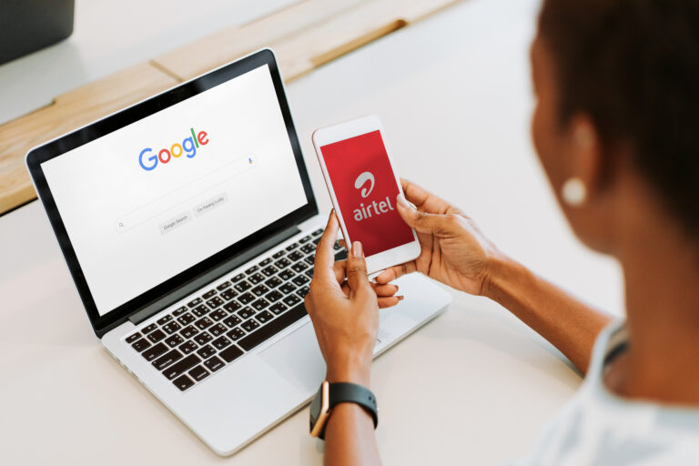 Woman using laptop and smartphone