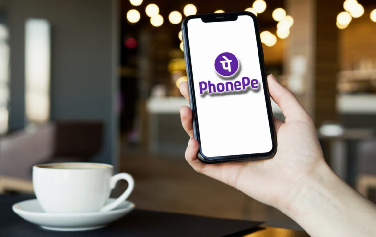 A person paying using PhonePe app at a Coffee Shop