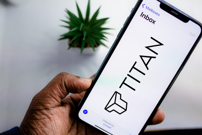 Person Holding Android Smartphone showcasing email startup Titan logo