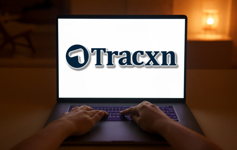 Person Using Macbook Pro on Brown Wooden Table