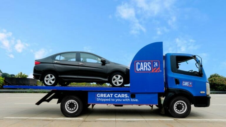 Car loaded on Cars24 delivery truck