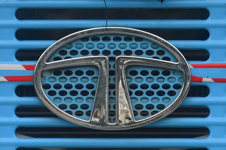 Tata Motors logo is seen on the engine grille of a truck