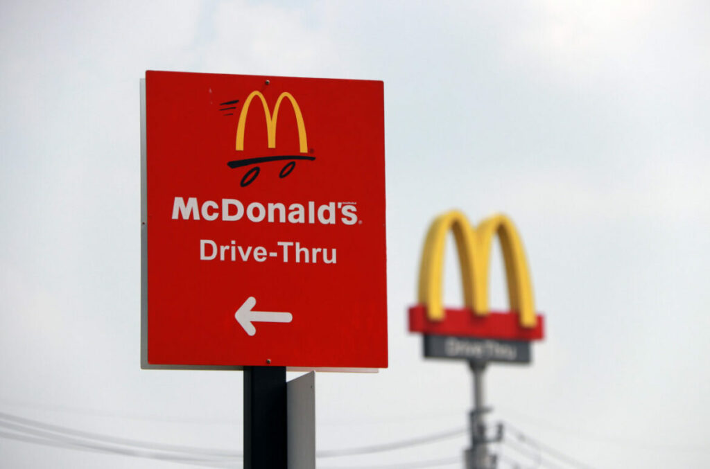 PakKret, Nonthaburi, Thailand - March 1, 2018: The red sign of McDonald drive thru at daylight and out focus dicut style of McDonald's logo. The McDonald's Corporation is the world's famous restaurant