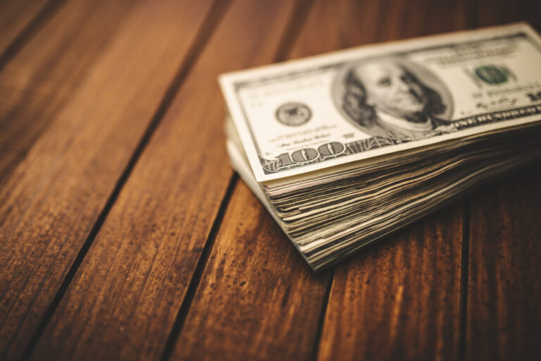 Dollar bills bundle on table