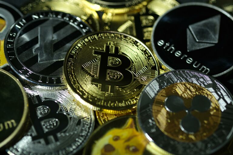 visual representations of digital cryptocurrencies, Bitcoin (BTC), Ethereum (ETH), Ripple (XRP), Litecoin (LTC) and Dogecoin (DOGE)