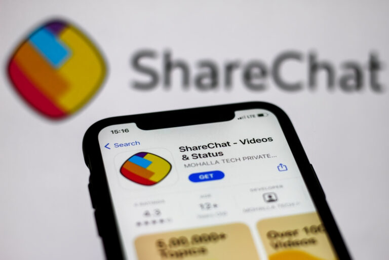 ShareChat logo on the App Store displayed on a phone screen and ShareChat logo in the background are seen in this illustration