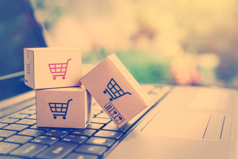 Close-Up Of Small Shopping Boxes With Credit Card On Laptop