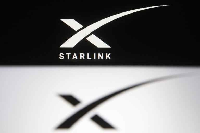 In this photo illustration a Starlink logo of a satellite
