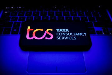 Tata Consultancy Services logo displayed on a phone screen and a laptop keyboard are seen in this illustration photo