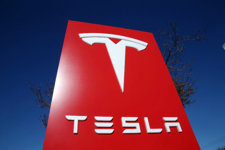 A sign is posted at a Tesla showroom