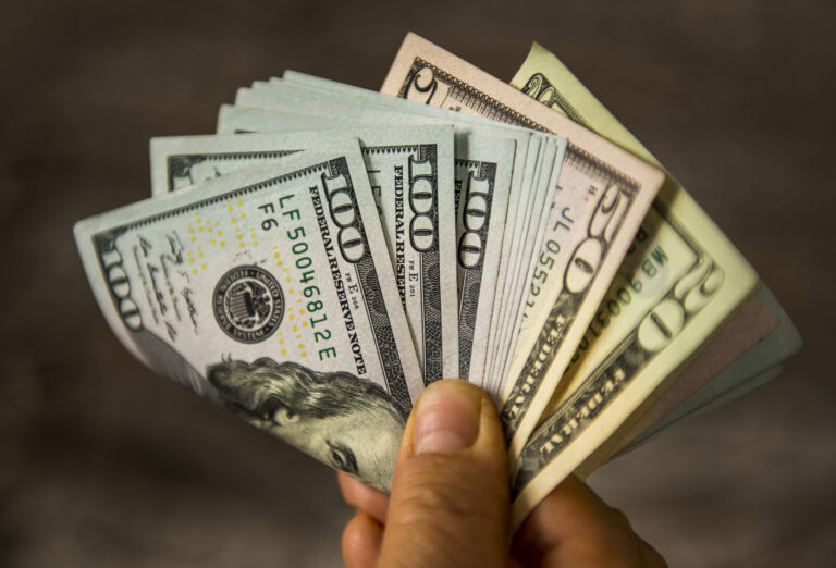 Man holding US Dollar bills. High angle view. Horizontal composition