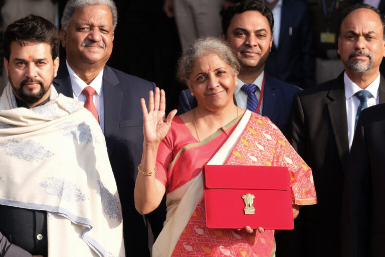 Nirmala Sitharaman, India's finance minister, center, Anurag Thakur, India's finance and corporate affairs minister, left, and other members of the finance ministry leave the North Block of the Central Secretariat building in New Delhi