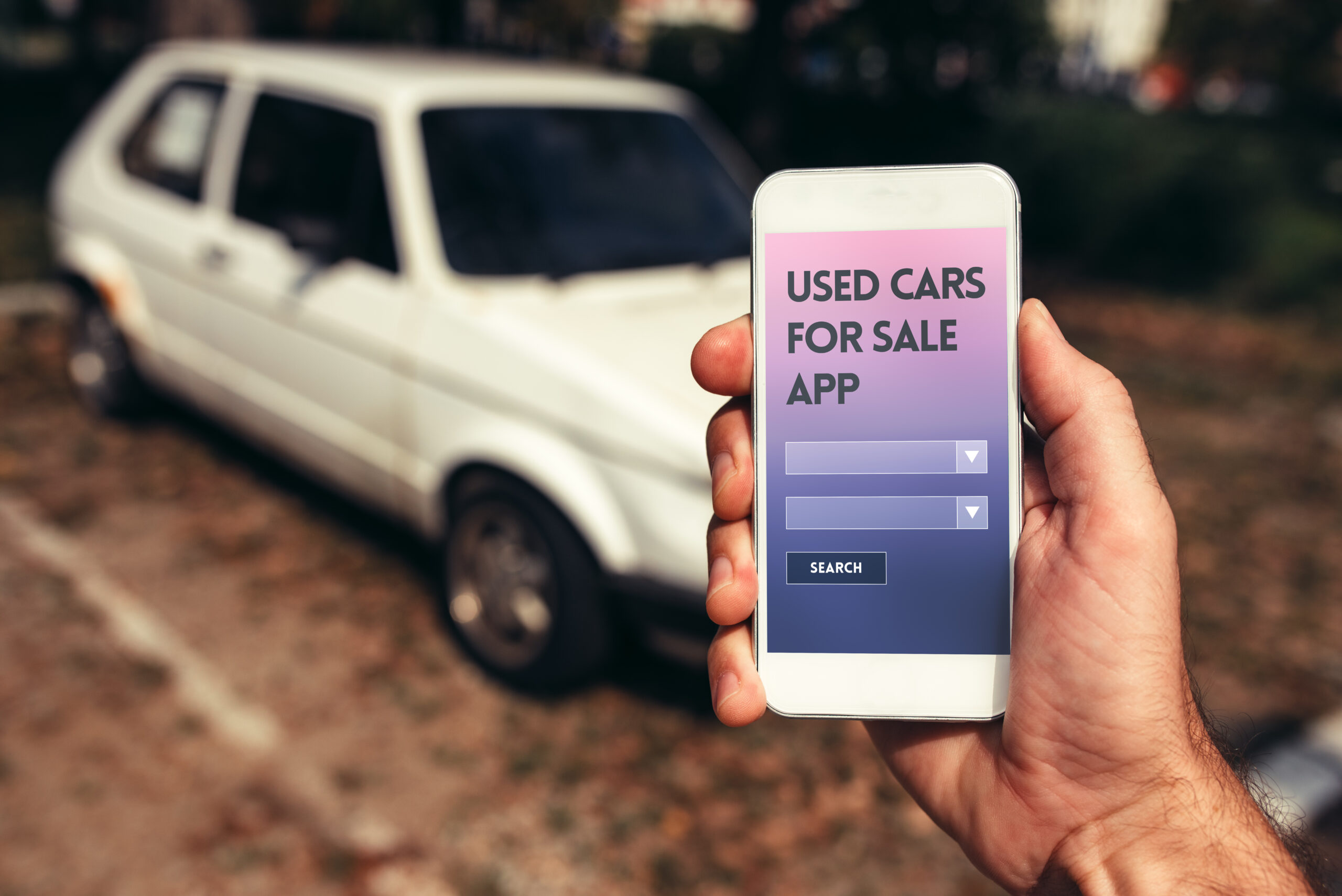 Used cars smartphone app mock up, vehicle dealer holding mobile phone