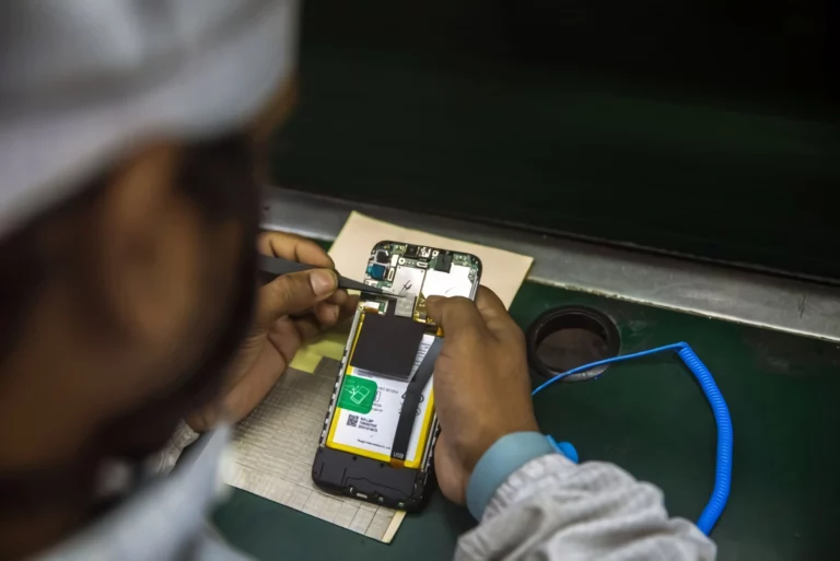 A worker manufactures a smart phones on an assembly line at the Lava International Ltd. factory in Noida, Uttar Pradesh, India
