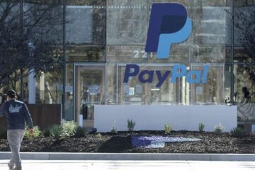A passerby in front of a PayPal office