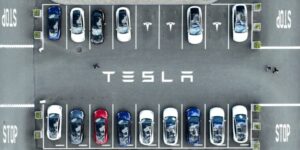 Aerial view of Tesla cars parked at a Tesla showroom