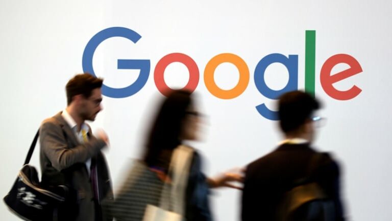 Hazy image depicted of workers in front of Google logo