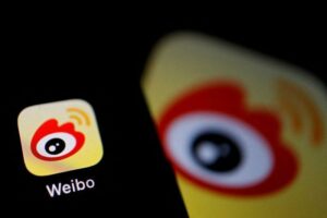 Weibo logo visible shown on a screen with the same as the background