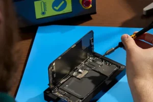 A worker repairs a smartphone