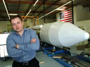 Elon Musk, the founder of SpaceX, stands beside a rocket in Los Angeles in 2004