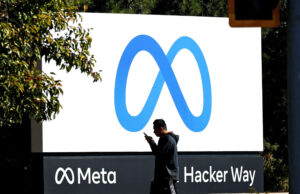 MENLO PARK, CALIFORNIA - OCTOBER 28: A pedestrian walks in front of a new logo and the name 'Meta' on the sign in front of Facebook headquarters on October 28, 2021 in Menlo Park, California.