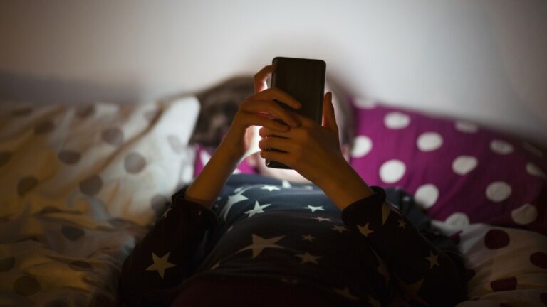 Image showing a child using their phone at night