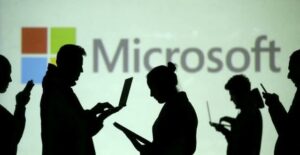 A group of users depicted as shadows in front of Microsoft logo