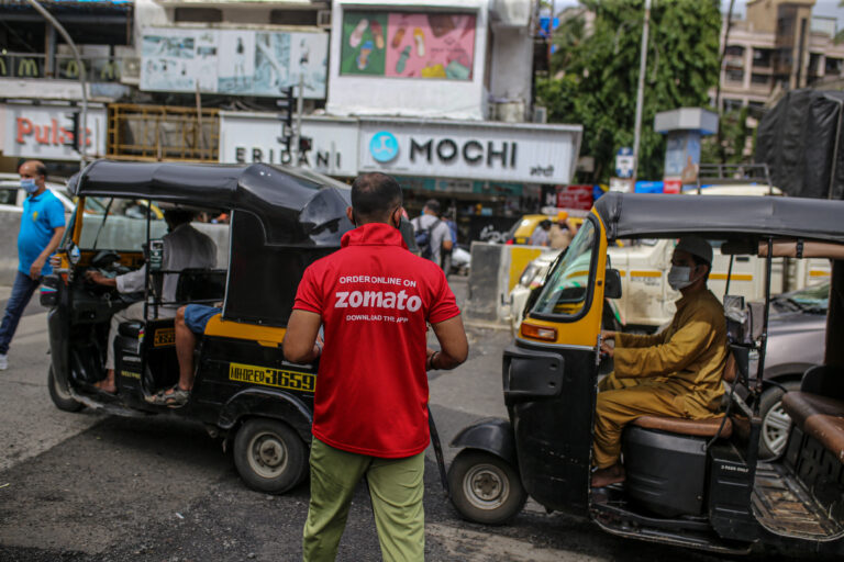 A food delivery rider for Zomato Media Pvt., carries an order from a restaurant in Mumbai, India.