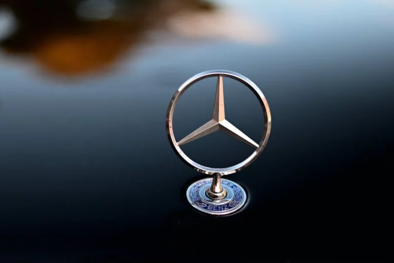 Logo of Mercedes Benz on a black surface