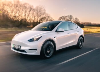 A white Tesla Model Y on the road