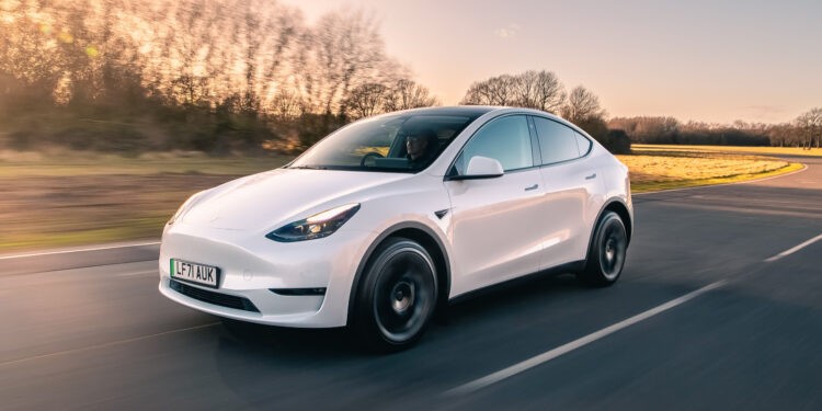 A white Tesla Model Y on the road