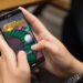 gambling concept: girl using a digital generated phone with online casino on the screen. All screen graphics are made up.