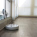White robotic vacuum cleaner and robot window cleaner work together. Smart cleaning technology.