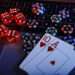 Casino play online theme. Playing chips, cards and dices on laptop close-up.