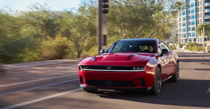 The Dodge Charger Daytona R/T will not be part of the 2026 model year lineup, according to Dodge CEO Matt McAlear. While Dodge hasn’t completely ruled out the trim’s return in the future, the automaker has officially postponed its production for now. The reason? A combination of market shifts and uncertainties surrounding U.S. tariff policies. "Production of the Dodge Charger Daytona R/T is postponed for the 2026 model year as we continue to assess the effects of U.S. tariff policies,” McAlear said in a statement to Motor1. Instead, Dodge will sharpen its focus on high-performance offerings, like the Charger Daytona Scat Pack, and upcoming internal combustion alternatives. Scat Pack Takes Center Stage With the R/T trim off the table, the Daytona Scat Pack now becomes the sole all-electric Charger variant available for 2026. And it’s no slouch. Delivering 670 horsepower from its dual-motor setup, the Scat Pack is targeting mid-11-second quarter-mile times. However, the performance comes at the cost of range, 241 miles per the EPA estimate, a step down from the R/T’s 308 miles. That boost in performance also brings a steeper price tag. The Scat Pack will sit around $60,000 after factoring in the $7,500 federal EV tax credit. In contrast, the now-shelved R/T was expected to be a more accessible entry point to the electric muscle segment, slipping in under $50,000 with the same tax break. Lagging Sales, Overstuffed Lots Market data supports Dodge’s decision. Charger sales fell by a staggering 54 percent in 2024. The first-quarter sales of electric Chargers in 2025 totaled just 1,947 units, a mix of both R/T and Scat Pack trims. Meanwhile, Mopar Insiders reported that approximately 3,500 R/T units are still sitting unsold in dealer inventories. This lukewarm reception has highlighted a broader issue: despite the impressive specs, the brand’s electric offerings haven’t captured the hearts of traditional Dodge enthusiasts, many of whom remain loyal to internal combustion. The Sixpack Rises To address this, Dodge is introducing a new four-door variant, the Charger Sixpack, aimed at muscle fans not quite ready to embrace electrification. Powered by a twin-turbocharged 3.0-liter inline-six engine, the Sixpack will be available in both standard-output (420 hp) and high-output (550 hp) trims. Though exact pricing hasn’t been revealed, it's expected to slot in around the price point previously held by the R/T. The new platform, STLA Large, is designed to support both EVs and ICE models, giving Dodge flexibility to pivot as demand dictates. Looking Ahead While the Charger Daytona R/T may be gone for now, its future isn’t completely off the table. Dodge is keeping a close eye on market dynamics, government policies, and consumer behavior as it fine-tunes its approach. With the Scat Pack holding the electric torch and the Six Pack catering to combustion purists, Dodge’s strategy appears focused on streamlining its offerings while covering both sides of the propulsion spectrum. As more details about the 2026 Charger lineup emerge, muscle car fans and industry watchers alike will be paying close attention. The muscle car isn’t dead, it’s just adapting.