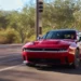 The Dodge Charger Daytona R/T will not be part of the 2026 model year lineup, according to Dodge CEO Matt McAlear. While Dodge hasn’t completely ruled out the trim’s return in the future, the automaker has officially postponed its production for now. The reason? A combination of market shifts and uncertainties surrounding U.S. tariff policies. "Production of the Dodge Charger Daytona R/T is postponed for the 2026 model year as we continue to assess the effects of U.S. tariff policies,” McAlear said in a statement to Motor1. Instead, Dodge will sharpen its focus on high-performance offerings, like the Charger Daytona Scat Pack, and upcoming internal combustion alternatives. Scat Pack Takes Center Stage With the R/T trim off the table, the Daytona Scat Pack now becomes the sole all-electric Charger variant available for 2026. And it’s no slouch. Delivering 670 horsepower from its dual-motor setup, the Scat Pack is targeting mid-11-second quarter-mile times. However, the performance comes at the cost of range, 241 miles per the EPA estimate, a step down from the R/T’s 308 miles. That boost in performance also brings a steeper price tag. The Scat Pack will sit around $60,000 after factoring in the $7,500 federal EV tax credit. In contrast, the now-shelved R/T was expected to be a more accessible entry point to the electric muscle segment, slipping in under $50,000 with the same tax break. Lagging Sales, Overstuffed Lots Market data supports Dodge’s decision. Charger sales fell by a staggering 54 percent in 2024. The first-quarter sales of electric Chargers in 2025 totaled just 1,947 units, a mix of both R/T and Scat Pack trims. Meanwhile, Mopar Insiders reported that approximately 3,500 R/T units are still sitting unsold in dealer inventories. This lukewarm reception has highlighted a broader issue: despite the impressive specs, the brand’s electric offerings haven’t captured the hearts of traditional Dodge enthusiasts, many of whom remain loyal to internal combustion. The Sixpack Rises To address this, Dodge is introducing a new four-door variant, the Charger Sixpack, aimed at muscle fans not quite ready to embrace electrification. Powered by a twin-turbocharged 3.0-liter inline-six engine, the Sixpack will be available in both standard-output (420 hp) and high-output (550 hp) trims. Though exact pricing hasn’t been revealed, it's expected to slot in around the price point previously held by the R/T. The new platform, STLA Large, is designed to support both EVs and ICE models, giving Dodge flexibility to pivot as demand dictates. Looking Ahead While the Charger Daytona R/T may be gone for now, its future isn’t completely off the table. Dodge is keeping a close eye on market dynamics, government policies, and consumer behavior as it fine-tunes its approach. With the Scat Pack holding the electric torch and the Six Pack catering to combustion purists, Dodge’s strategy appears focused on streamlining its offerings while covering both sides of the propulsion spectrum. As more details about the 2026 Charger lineup emerge, muscle car fans and industry watchers alike will be paying close attention. The muscle car isn’t dead, it’s just adapting.