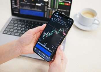 Example of a trading app interface on a phone, via Pexels