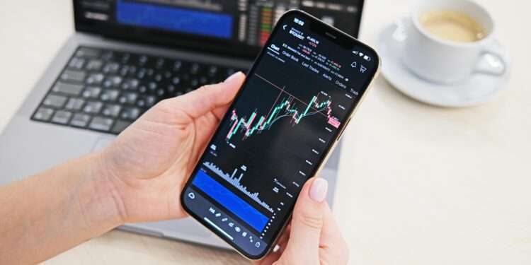 Example of a trading app interface on a phone, via Pexels