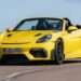 Porsche is preparing one of the most dramatic strategy reversals in its modern history. The next-generation 718 Boxster and Cayman, originally engineered to go fully electric, are now being reworked to accept petrol engines once again. Senior engineering sources at Porsche’s Weissach R&D centre have confirmed that the company is actively adapting the upcoming PPE Sport platform, designed for electric sports cars, to support a mid-mounted internal combustion engine. It’s a sharp U-turn driven by slowing EV demand and changing regulatory realities. Why Porsche Changed Course The fourth-generation 718 Boxster and Cayman ended production last month, clearing the runway for bespoke electric replacements expected in 2026. But the market didn’t cooperate. EV demand softened, and Porsche was forced into what it called a “strategic realignment,” taking a £6.65 billion financial hit in the process. As part of that rethink, Porsche had already committed to keeping high-performance RS and GT4 RS versions of the current 718 alive. What’s new is far bigger: a full petrol-powered return built on a platform never meant to host an engine. One Porsche engineer summed it up bluntly: the electric Boxster and Cayman “risked becoming a niche.” Re-Engineering an EV Platform for Petrol The PPE Sport platform uses a stressed, load-bearing battery pack as a core structural element. Remove that battery, and the car loses much of its rigidity. That’s the central challenge Porsche engineers are now tackling. The proposed solution involves developing a new structural floor section that bolts into existing hard points, restoring stiffness lost by removing the battery. A redesigned rear bulkhead and subframe would then support the engine and transmission. Fuel tanks, exhaust routing, and cooling systems would require a completely new rear architecture, as the EV layout has no central tunnel or fuel provisions. This approach mirrors recent industry pivots by brands like Fiat and Mercedes-Benz, but at a far higher performance and engineering level. Dynamic Parity Is the Non-Negotiable Internally, Porsche has set a tough benchmark. Any fifth-generation petrol 718 must match the dynamic performance of its electric sibling. That’s no small task given the EV’s ultra-low centre of gravity and rigid skateboard structure. Engineers acknowledge that achieving parity will be expensive and complex, but essential if the petrol models are to carry the Porsche badge credibly into the 2030s. Euro 7 and E-Fuels Change the Game Regulation played a key role in reopening the petrol door. Porsche previously believed its naturally aspirated 4.0-litre flat-six wouldn’t survive strict Euro 7 emissions rules. However, the final diluted regulation, combined with the EU’s post-2035 e-fuel exemption, has shifted the business case. As a result, the leading candidate engine for the revived 718 is an evolved version of the 4.0-litre flat-six, potentially producing up to 493 bhp in GT4 RS trim. What Comes Next The petrol PPE Sport-based 718s are expected to act as a bridge until an all-new fifth-generation lineup arrives toward the end of the decade. For now, one thing is clear: Porsche isn’t ready to let internal combustion go quietly. And for enthusiasts, that’s very good news.